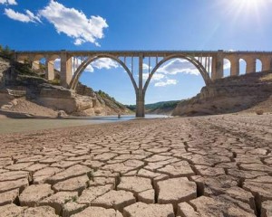 landscape of dry earth ground and viaduct, extreme drought in Entrepenas reservoir, in Guadalajara, Castilla, Spain Europe